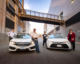 Clockwise left to right, Zoran Duric, associate professor; Professor Duminda Wijesekera, Department of Computer Science; and graduate students Yongxin Wang and Bo Yu conduct research on autonomous vehicles on the Mason Square Campus.