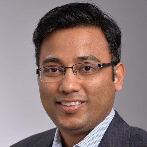 Moinul Hossain wears a gray suit and light-blue shirt in his faculty profile for the Cyber Security Engineering department.