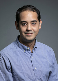 Cameron Nowzari wears a light-blue shirt in his faculty profile as a professor in the Department of Electrical and Computer Engineering
