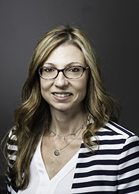Pelin Kurtay wears a striped cardigan, white blouse, and glasses in her faculty profile at the Department of Electrical and Computer Engineering