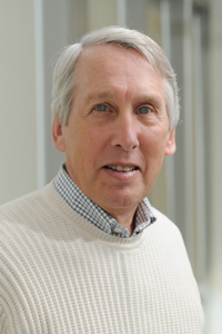A headshot of emeritus faculty Kenneth De Jong wearing a white sweater in his profile for the Computer Science department.