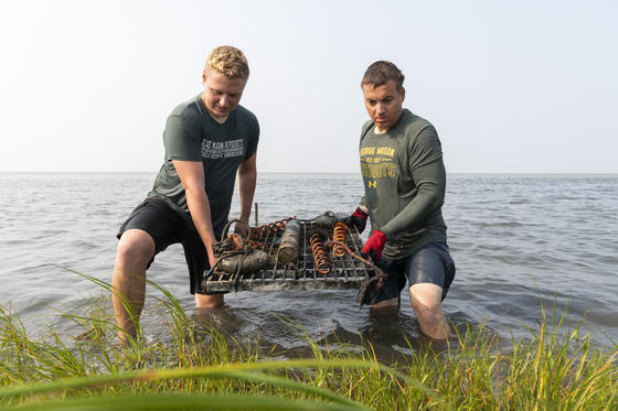 Associate professor Celso Ferriera and graduate student lift sensor out of the water