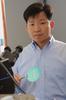 Mason professor Qiliang Li wears a light shirt in his faculty profile at his lab