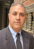Mason professor Bijan Jabbari is an older man wearing a gray suit and tie in his faculty profile